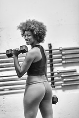 Image showing black woman doing bicep curls