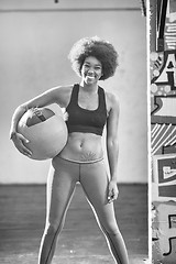 Image showing black woman carrying crossfit ball