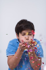 Image showing kid blowing confetti