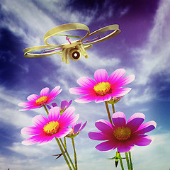 Image showing Drone, quadrocopter, with photo camera against the sky and Beaut