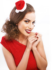 Image showing young pretty brunette woman in christmas red hat isolated