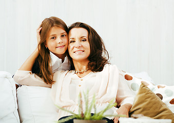Image showing happy mother with daughter at home, real family