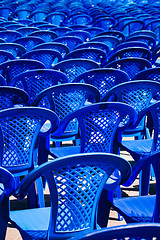 Image showing Bright plastic chairs standing in a row.