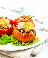 Image showing Tomatoes stuffed with rice and meat with lettuce in plate on boa