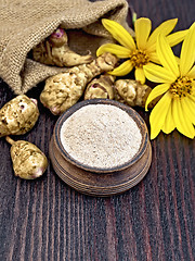 Image showing Flour of Jerusalem artichoke in clay bowl with flower on board