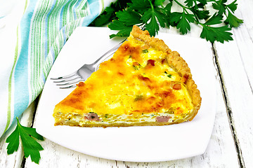 Image showing Quiche with pumpkin and bacon in white plate on wooden board