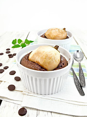 Image showing Cake with chocolate and pear in white bowl light board