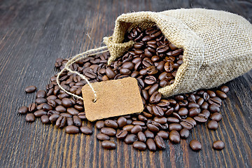 Image showing Coffee black grain with tag in bag on board