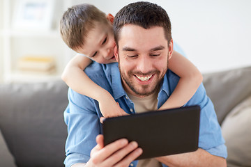 Image showing father and son with tablet pc playing at home