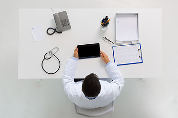 Image showing doctor with tablet pc and cardiogram at clinic