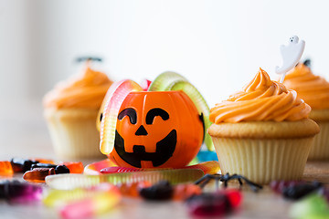 Image showing halloween party decorated cupcakes on wooden table