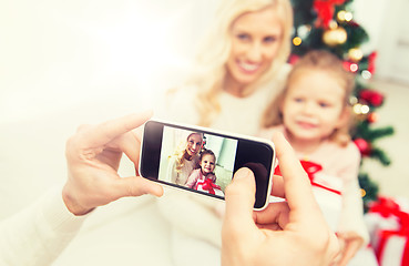 Image showing man taking picture of his family by smatrphone