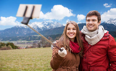 Image showing couple taking selfie by smartphone over alps 