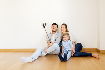 Image showing family taking selfie by smartphone at new home