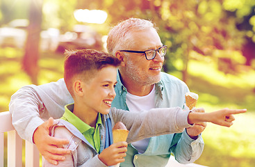 Image showing old man and boy eating ice cream at summer park