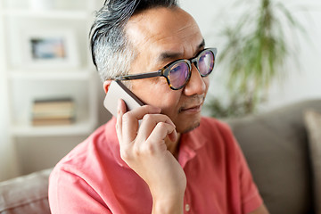 Image showing close up of asian man calling on smartphone