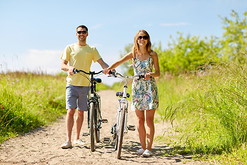 Image showing happy couple with bicycles on country road