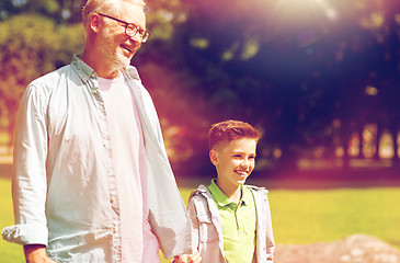 Image showing grandfather and grandson walking at summer park