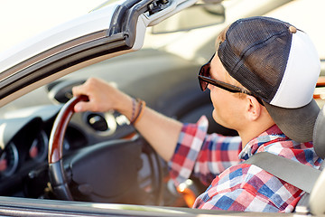 Image showing happy young man in shades driving convertible car