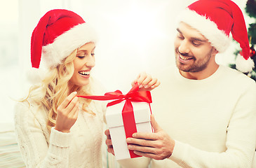 Image showing happy couple at home with christmas gift box