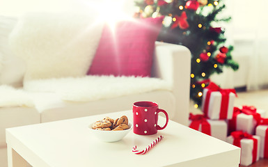 Image showing close up of christmas cookies, sugar cane and cup