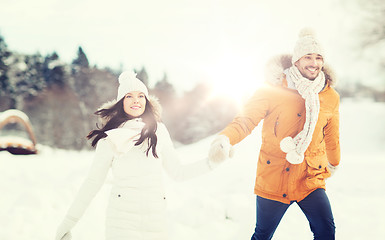 Image showing happy couple walking over winter background