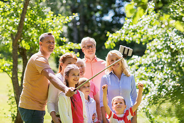 Image showing happy family taking selfie in summer garden