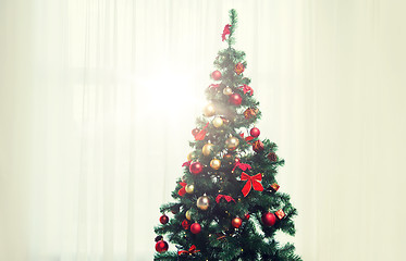Image showing christmas tree in living room over window curtain