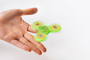 Image showing close up of hand playing with fidget spinner