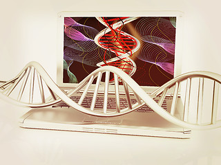 Image showing Laptop with dna medical model background on laptop screen. 3d il