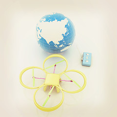 Image showing Quadrocopter Drone with Earth Globe and remote controller on a w