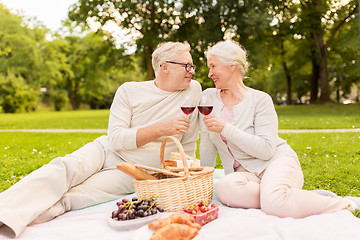 Image showing happy senior couple having picnic at summer park