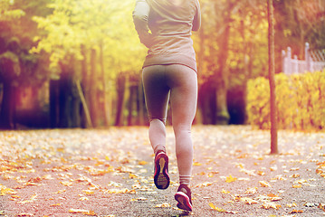 Image showing close up of young woman running in autumn park