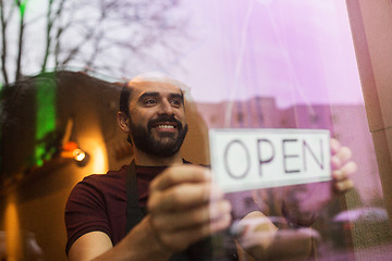 Image showing man with open banner at bar or restaurant window