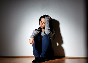 Image showing unhappy woman crying on floor at home