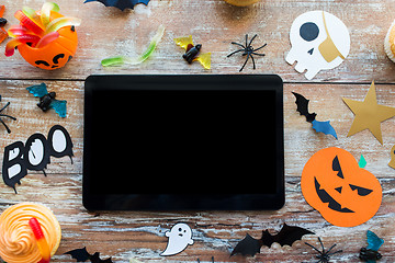 Image showing tablet pc, halloween party decorations and treats