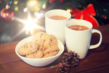 Image showing oat cookies and hot chocolate over christmas tree