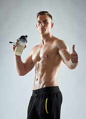 Image showing bodybuilder with protein shake showing thumbs up