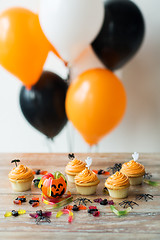 Image showing halloween party decorated cupcakes on wooden table