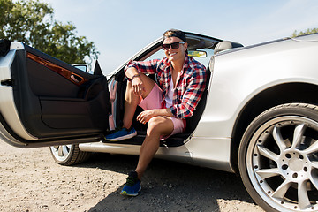 Image showing happy young man sitting in convertible car