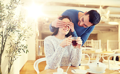 Image showing happy couple drinking tea at cafe