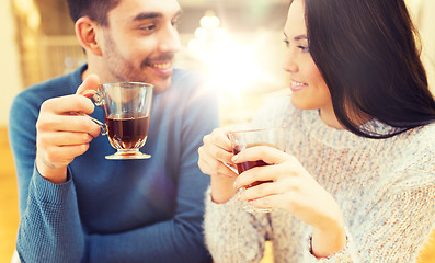 Image showing happy couple drinking tea at cafe