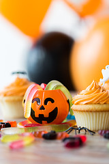 Image showing halloween party decorated cupcakes on wooden table