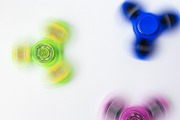 Image showing spinning fidget spinners on white background