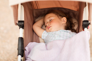 Image showing little child or baby sleeping in stroller outdoors