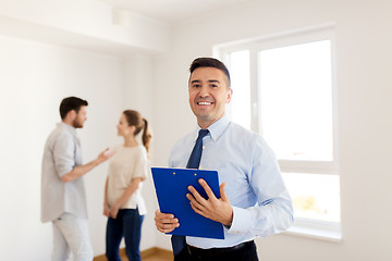 Image showing realtor with clipboard and couple at new home