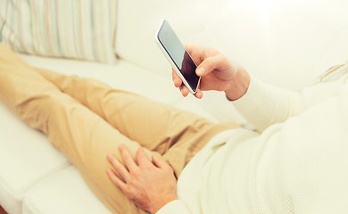 Image showing close up of man with smartphone at home