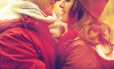 Image showing close up of happy young couple kissing outdoors