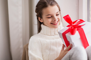 Image showing happy beautiful girl with christmas gift at home