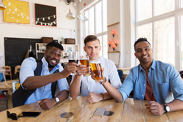 Image showing happy male friends drinking beer at bar or pub